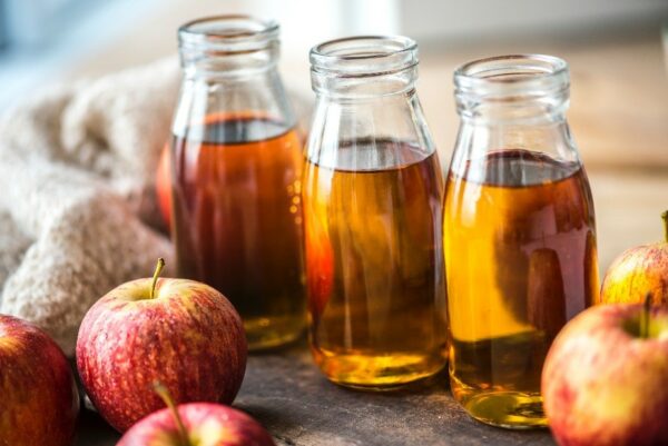 Three clear glass jars with apple cider vinegar in them.