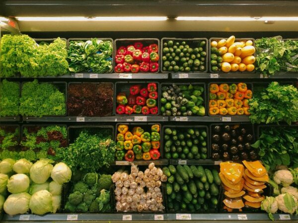 Produce section of a grocery store shows various vegetables.