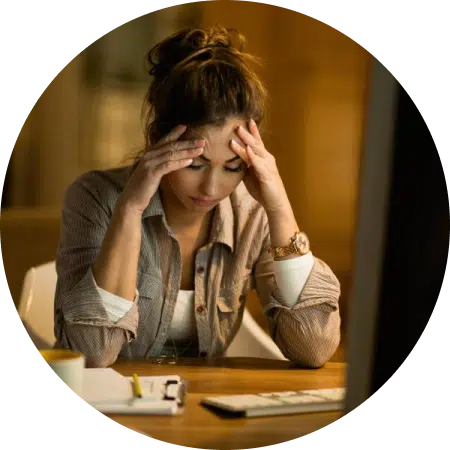 woman at table with her head in her hands